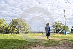 Woman walking outdoors in the field.