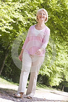 Woman walking outdoors smiling