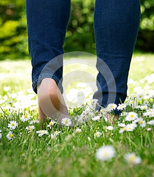 Woman walking in the park barefoot