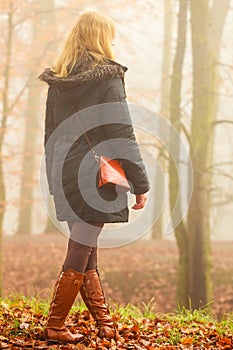 Woman walking in park in foggy day