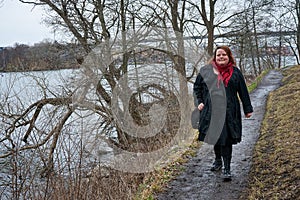 Woman walking on parth in park during winter