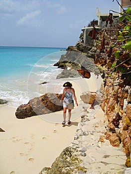 Woman walking on remote Caribbean Island beach