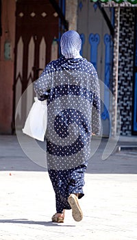 Woman walking, rocks, details in Morocco, in the desert, in Africa