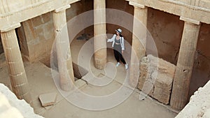 Woman walking on ruins of ancient temple
