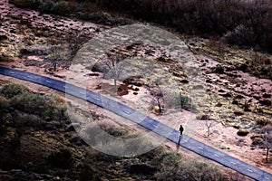 Woman Walking or Running on Path Bikepath in Desert Town