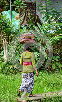 A woman walking on rural road in Bali, Indonesia