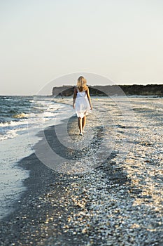 Woman walking on the sand of the beach