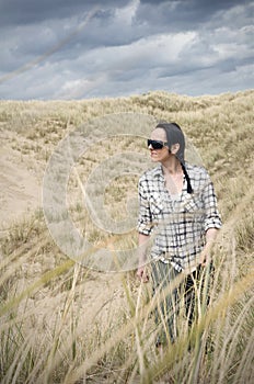 Woman walking in sand dunes