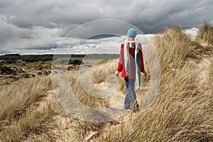 Woman walking in the sand dunes