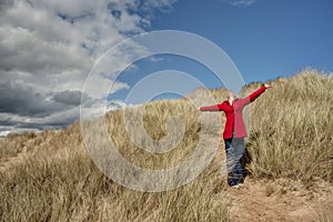 Woman walking in the sand dunes