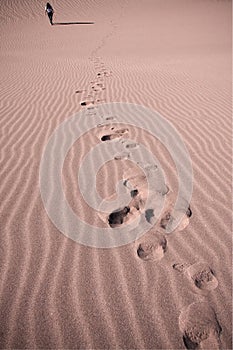 Woman walking on sand dunes in chile