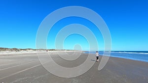 Woman walking sandy beach follow drive POV Texas 4K G04