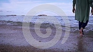 Woman walking into sea