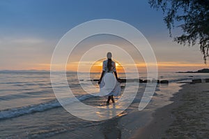 Woman walking at shore alone