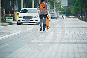 Woman walking with skateboard in hand