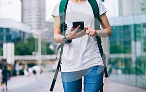 Woman walking with smart phone in modern city