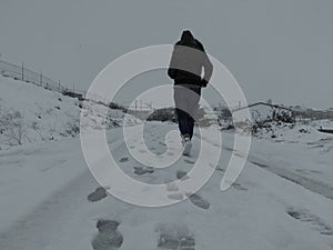 A woman walking through the snow photo