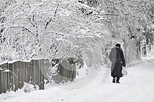 Woman walking on snowy road