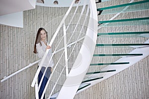 Woman walking on spiral stairs