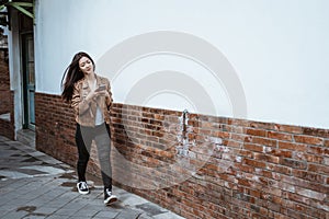 Woman walking in the street using phone