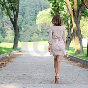 Woman walking on the summer park