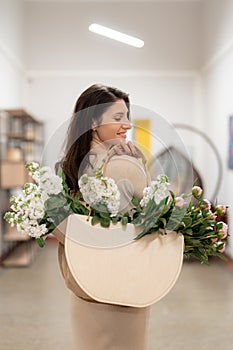 Woman walking to work with a bag with fresh flowers