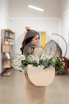 Woman walking to work with a bag with fresh flowers