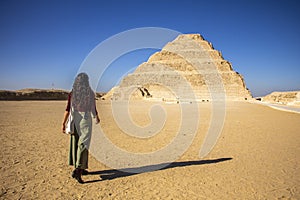 Woman walking towards Pyramid Djoser at Saqqara near Cairo