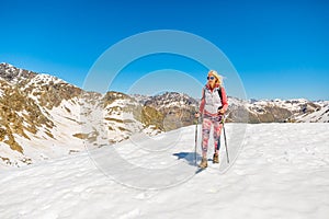 Woman walking with trekking poles