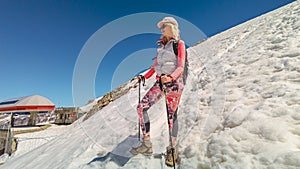 Woman walking with trekking poles