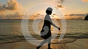 Woman Walking On The Tropical Beach At Sunset