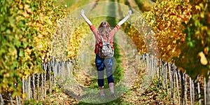 Woman walking in Tuscan vineyards in Val d`Orcia, Tuscany, Italy