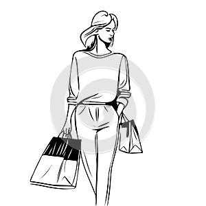 woman is walking with two shopping bags