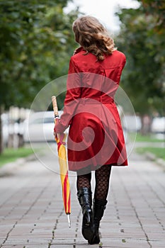 Woman walking with an umbrella