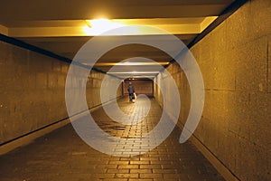 Woman walking through an underground pedestrian crossing