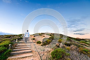 Woman walking up the pathway at Hallett Cove