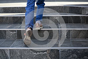 Woman walking up stylish stone stairs outdoors, closeup