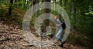 Woman Walking Uphill in Forest