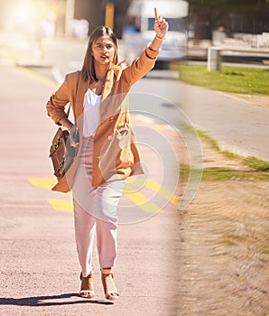 Woman, walking and wave to taxi in city for bus, cab or commute transportation and travel in cbd for business. Person