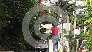 A Woman Walking In Windy Neighborhood