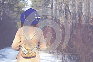 Woman walking in winter in the forest.