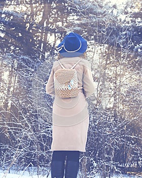 Woman walking in winter in the forest.