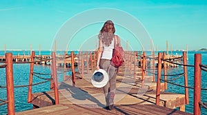 Woman walking on wooden pier