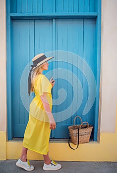 Woman walking in yellow dress at Paphos old city