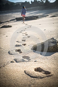 Woman Walks Alone on a Deserted Beach