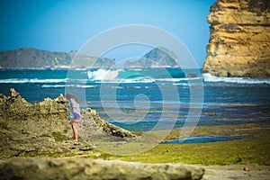 Woman Walks Alone on a Deserted Beach