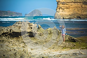 Woman Walks Alone on a Deserted Beach