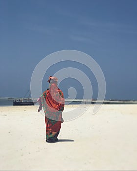 Woman Walks along the Beautiful Waters of Zanzibar