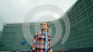 Woman Walks along European Flags near EU Commission Office in Brussels, Belgium.