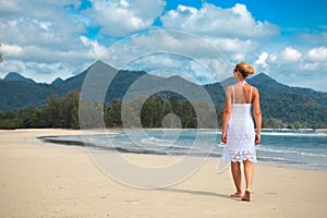 Woman walks on a beach